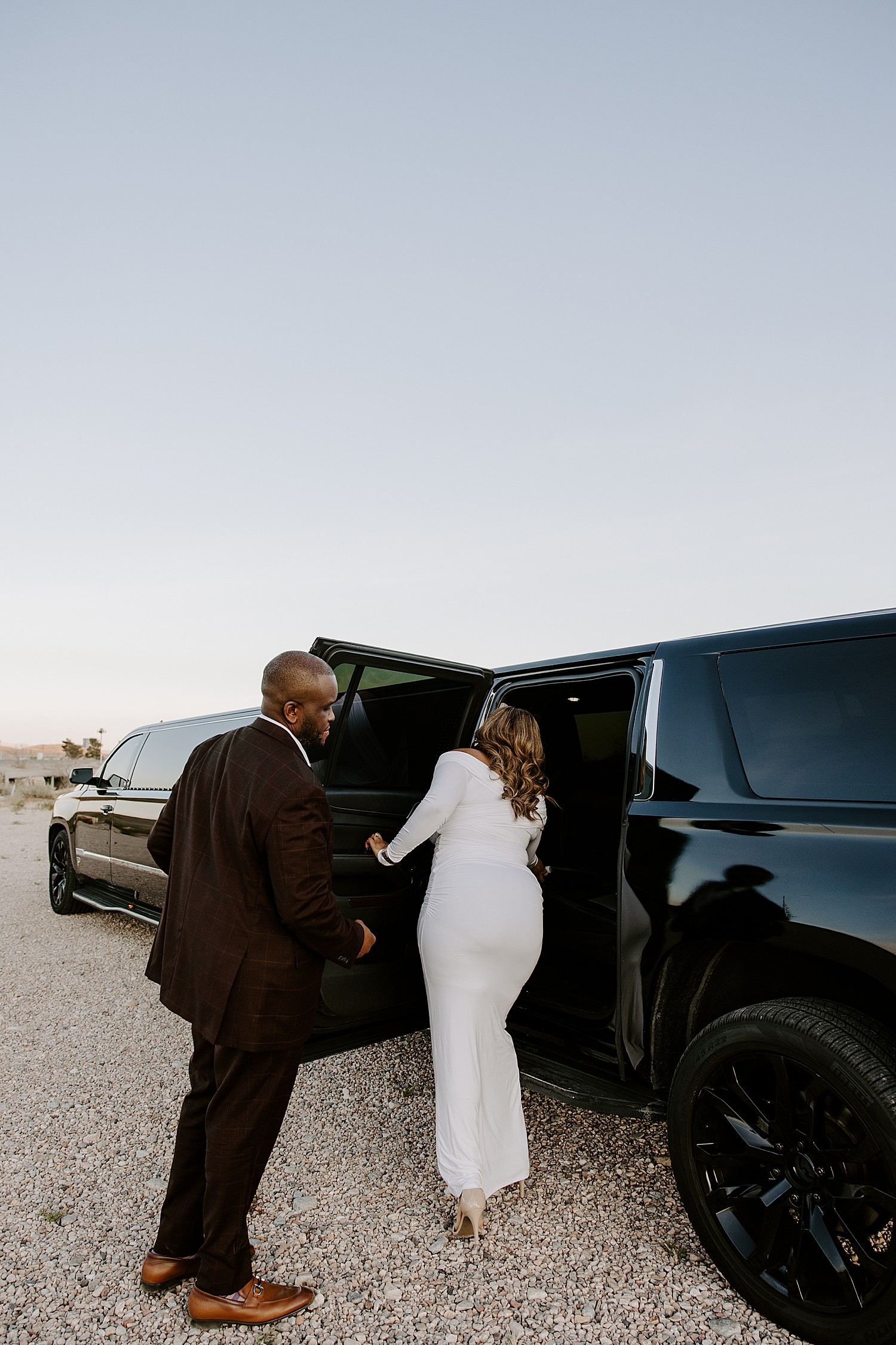 man helps new fiance into limo by Katelyn Faye Photo