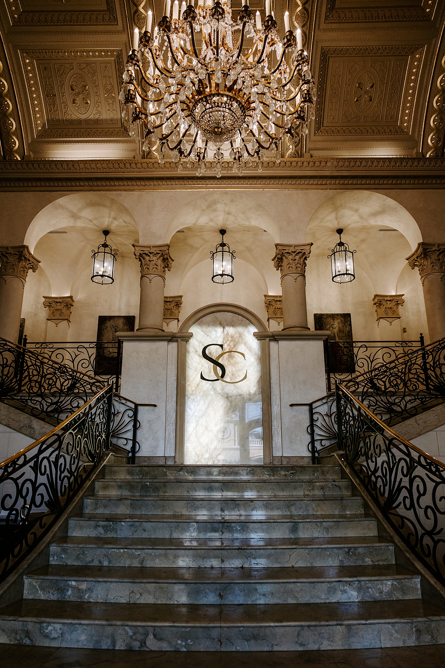 large ornate lobby with chandelier at The Stirling Club