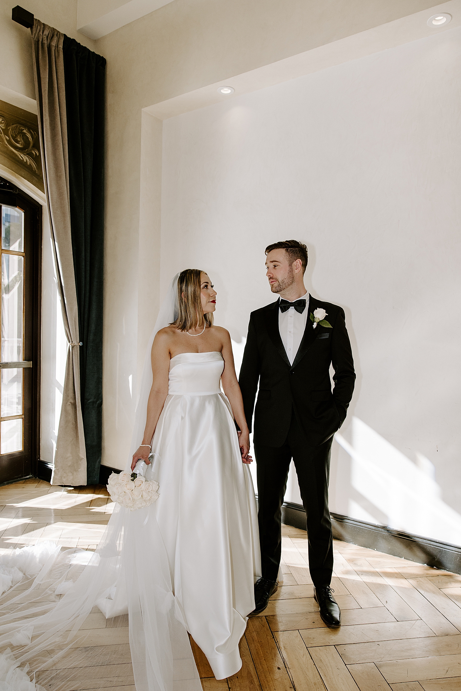 man looks at his bride fondly by Las vegas wedding photographer