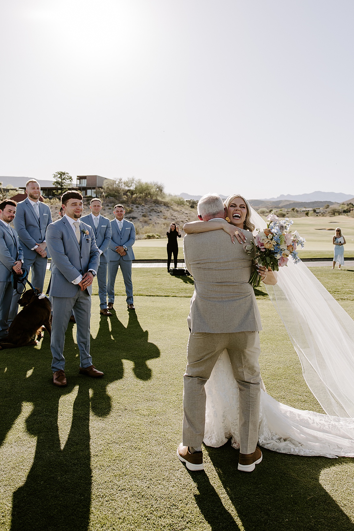 Bride smiles and hugs her father before getting married by Las Vegas Wedding Photographer