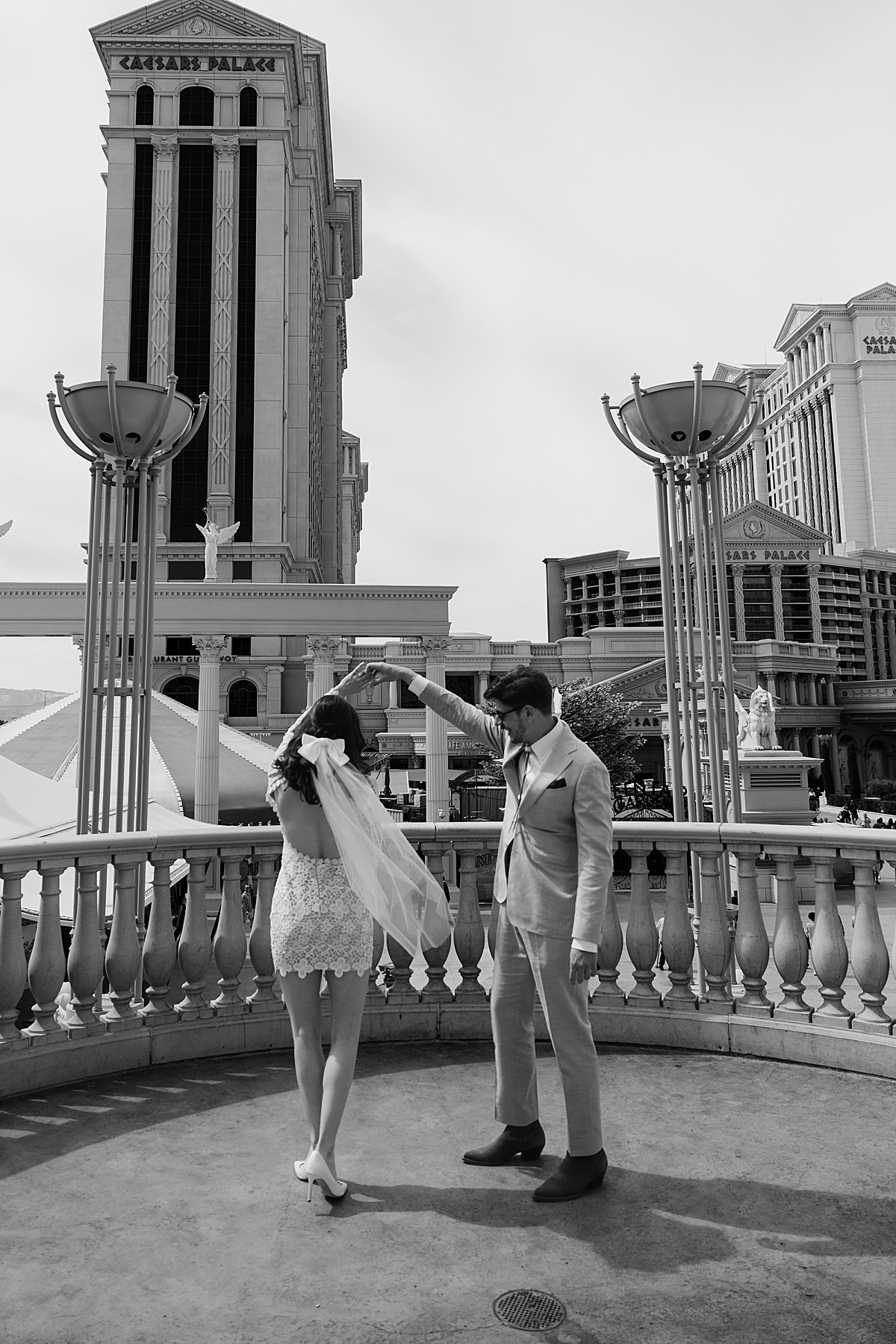 Man spins woman making her veil flow in the wind by Katelyn Faye Photo
