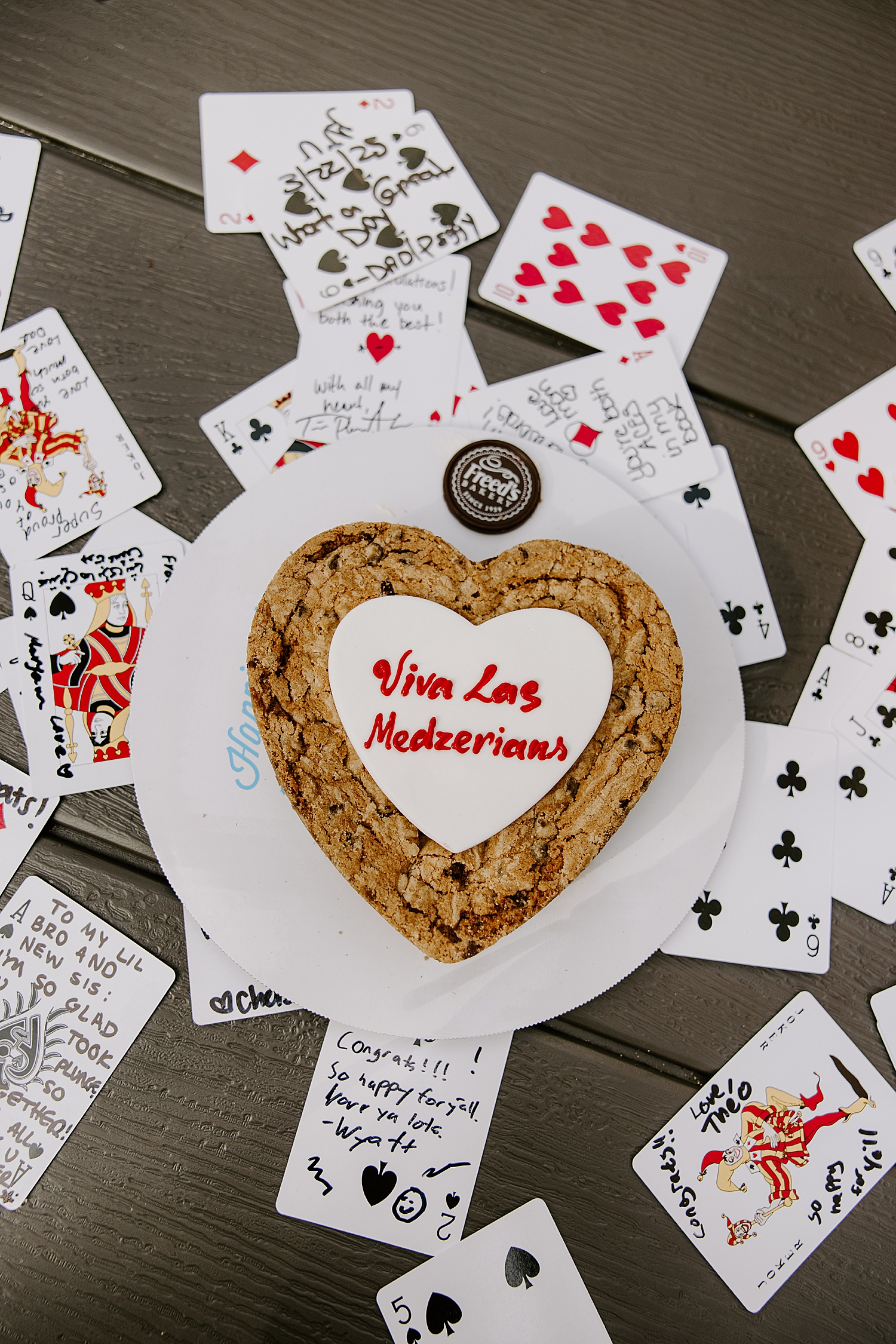 heart shaped cookie on plate on top of playing cards by Las Vegas wedding photographer