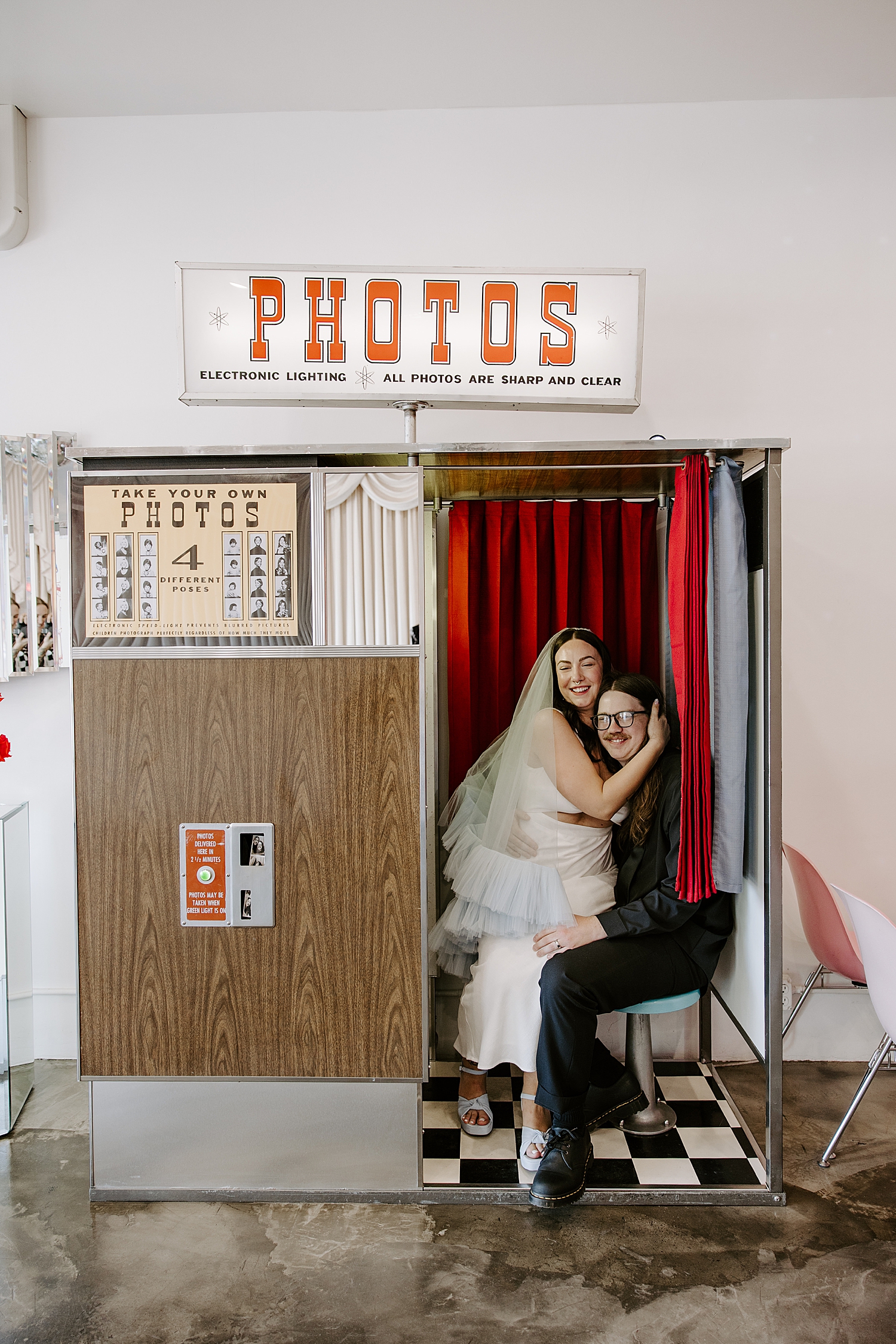 couple sits in photo booth after elopement by Katelyn Faye Photography