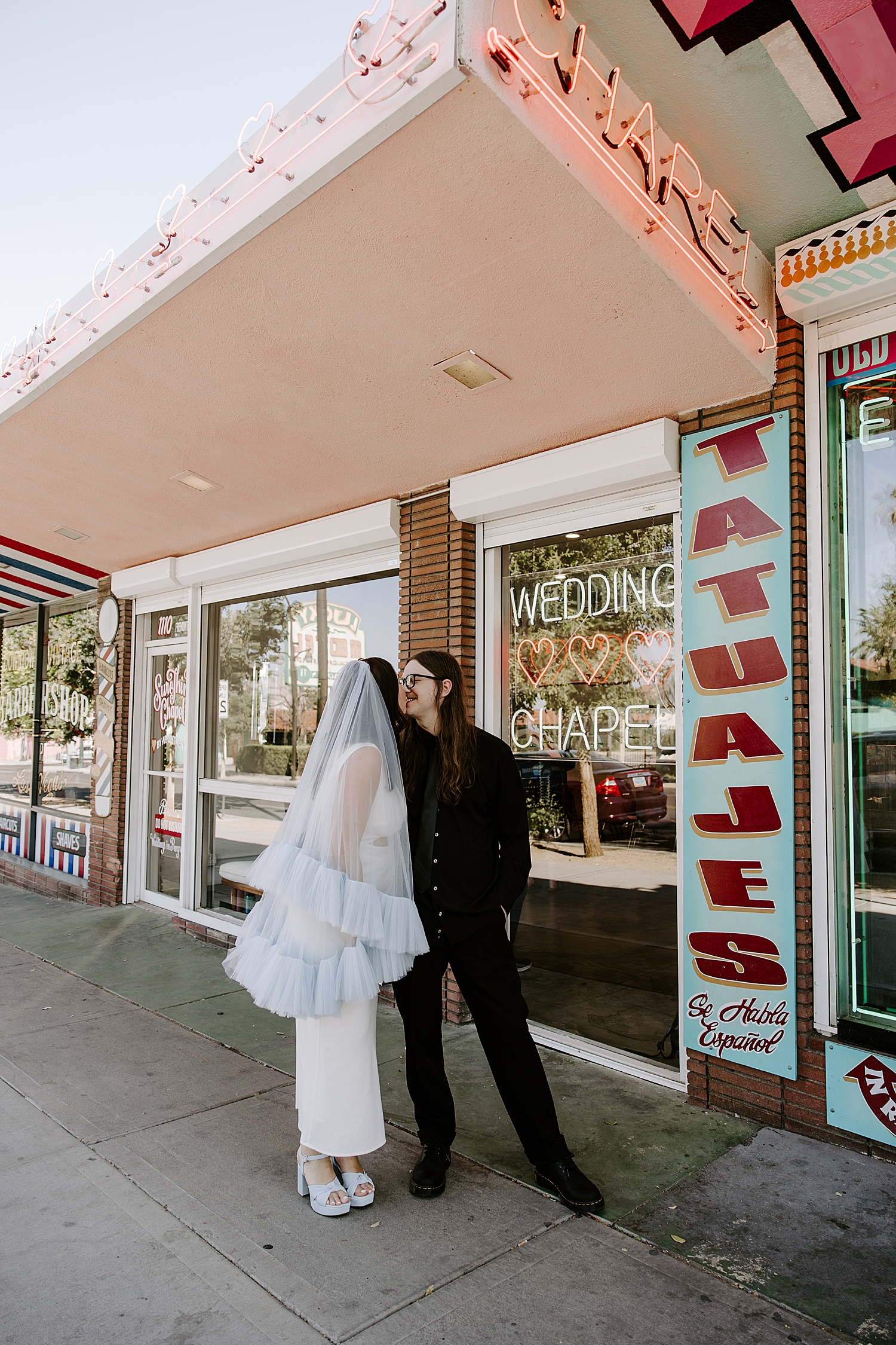 woman in tiered veil on sidewalk by Katelyn Faye Photography