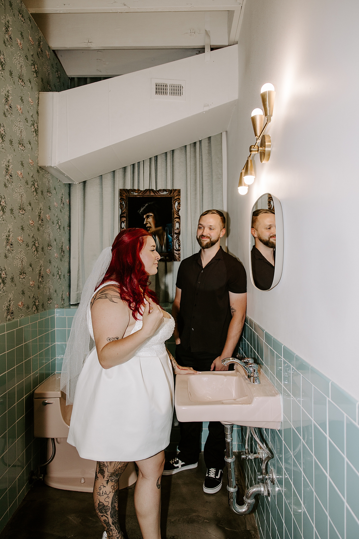 redhead adjusts her hair in the mirror after saying I Do by Katelyn Faye Photography