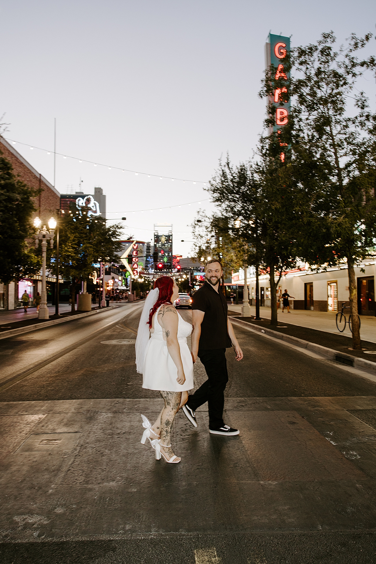 newlyweds cross lit up Vegas street after elopement by Katelyn Faye Photo