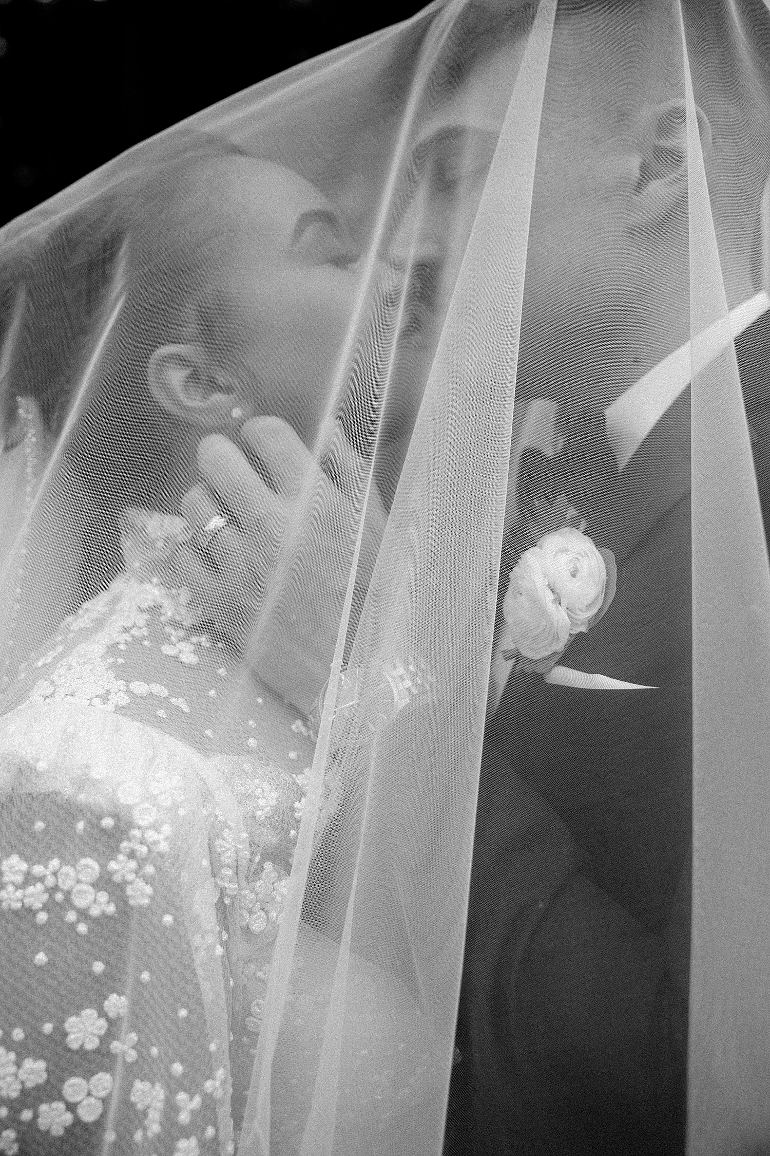 couple shares a kiss under a veil at their Boston Wedding