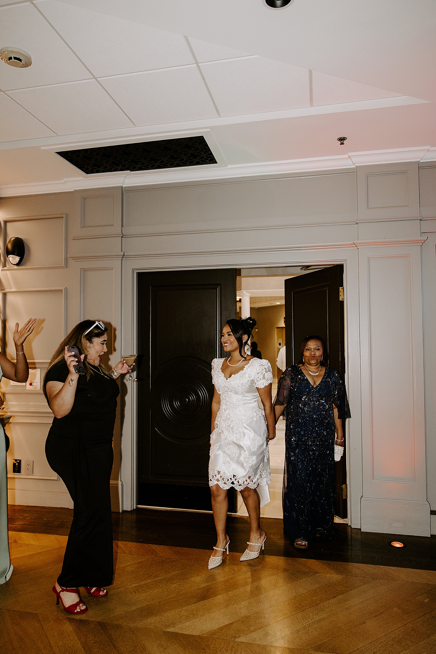 woman enters reception in new white dress at Boston Wedding