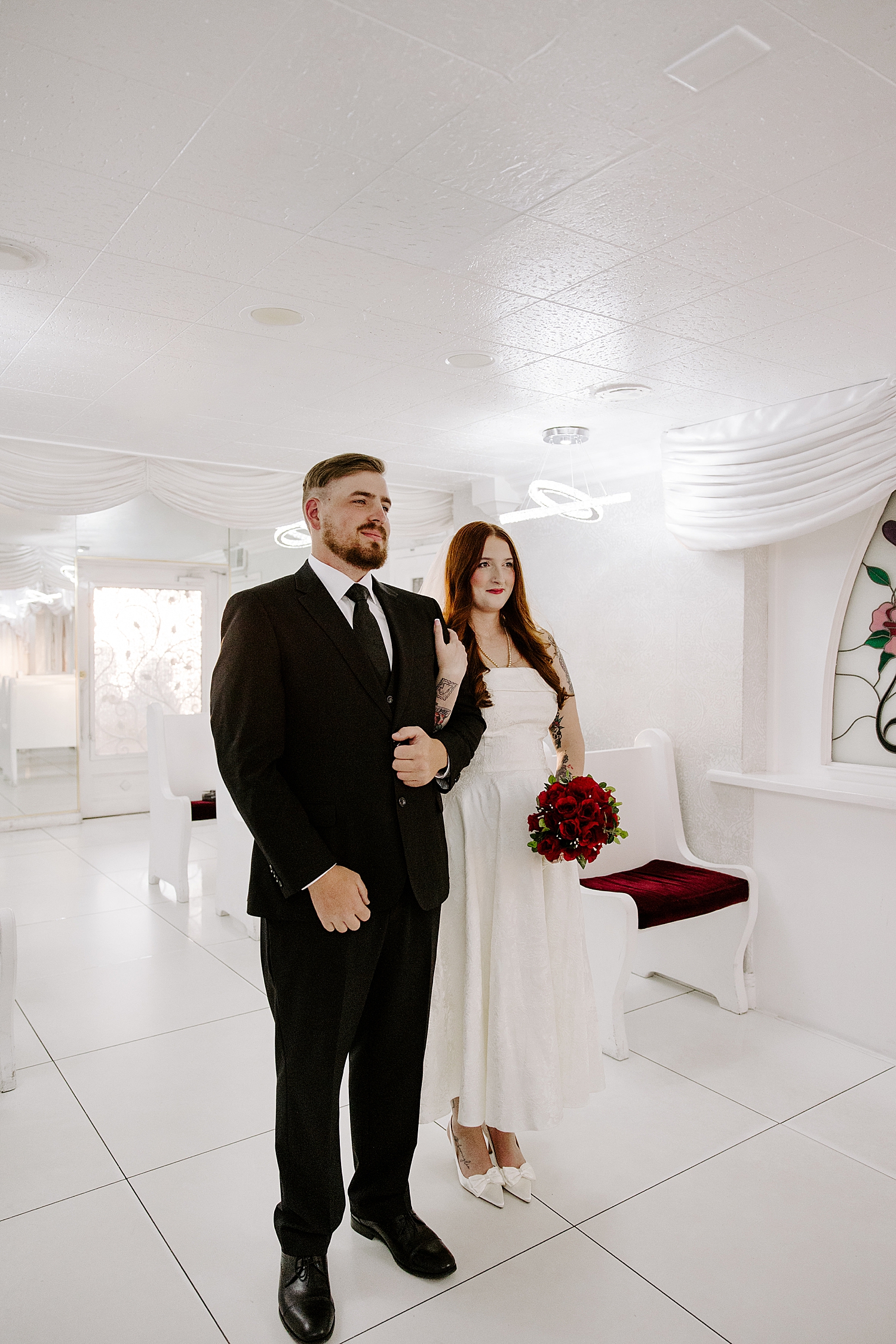bride and groom standing in the litte white chapel for vintage-inspired elopement