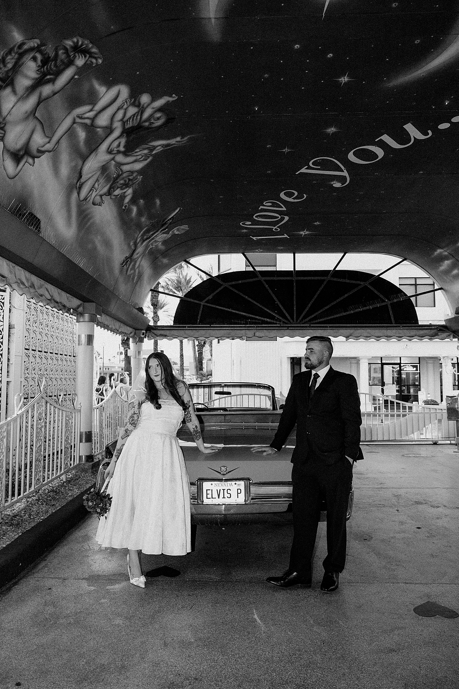 man and woman lean on corvette in Tunnel of Love by Katelyn Faye Photo