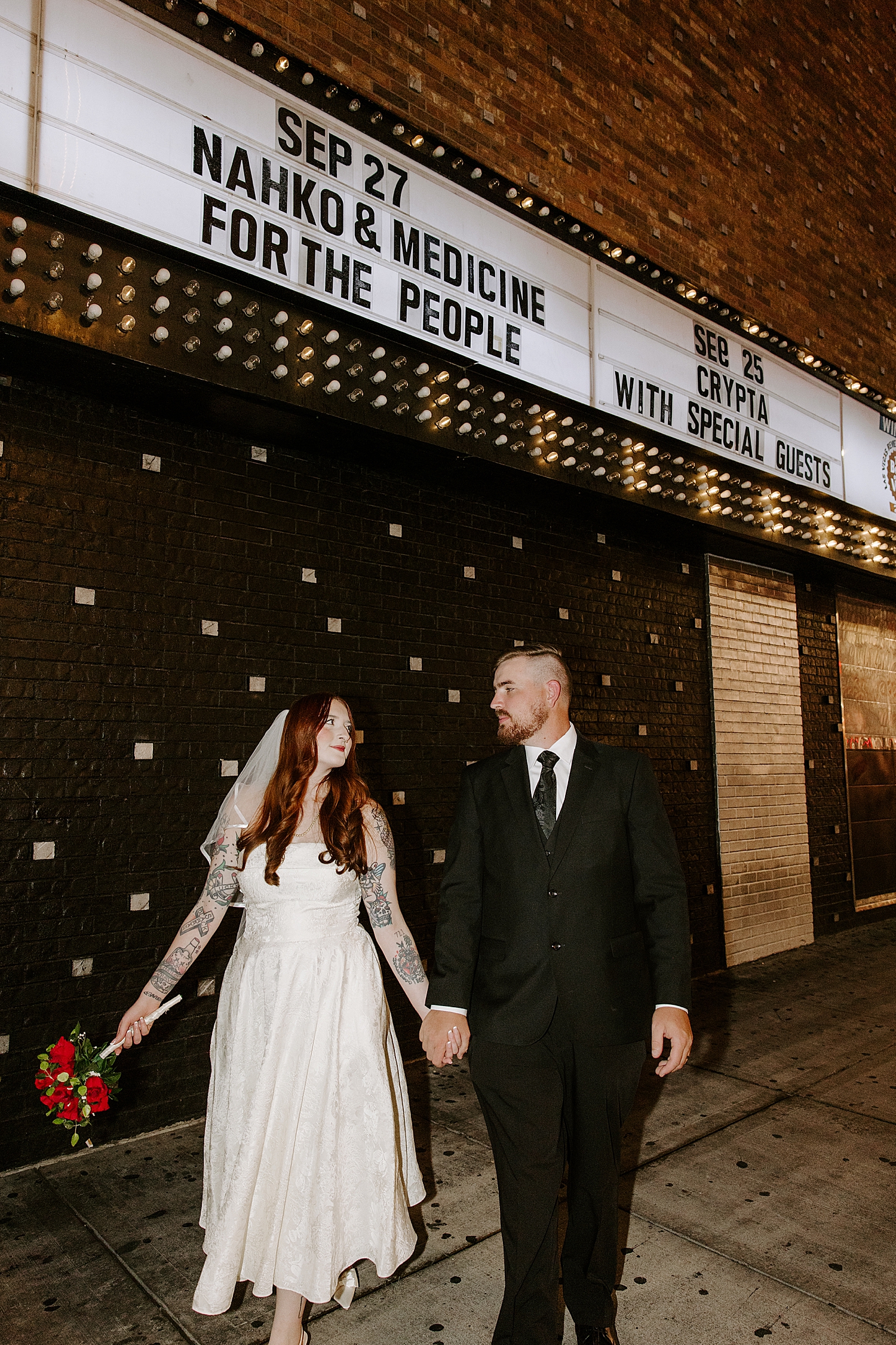 husband and wife walking down Fremont Street for vintage-inspired elopement
