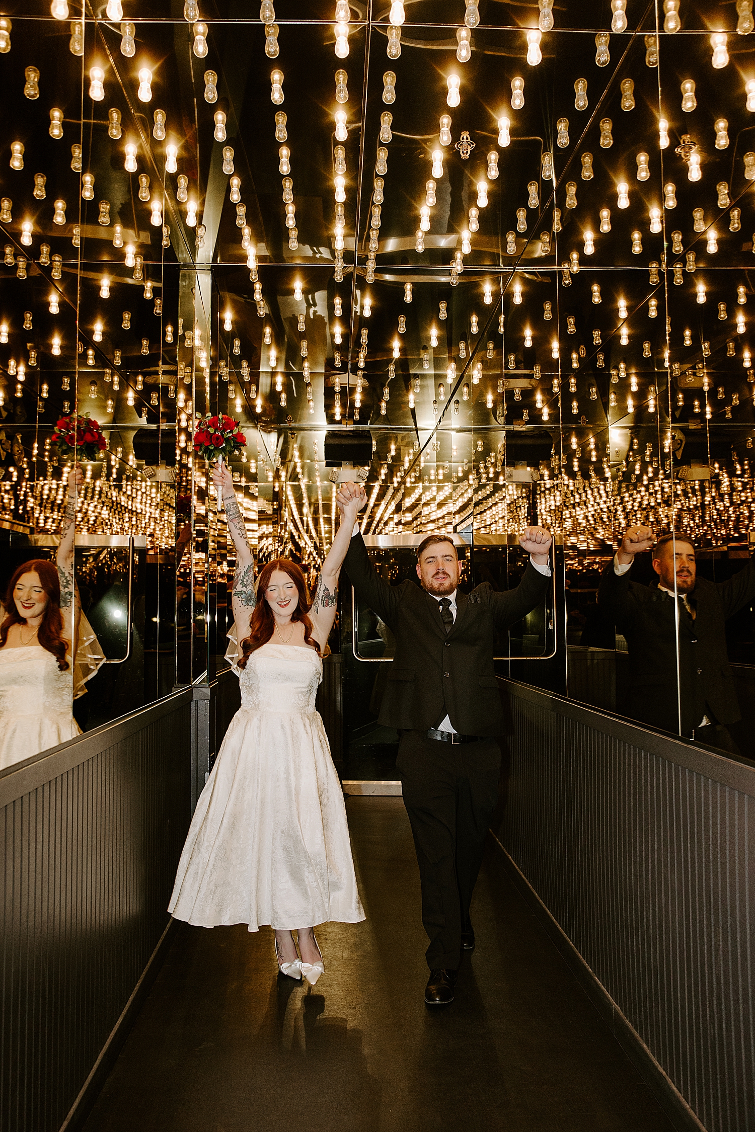 man and woman throw hands in the air after saying I Do by Las Vegas wedding photographer
