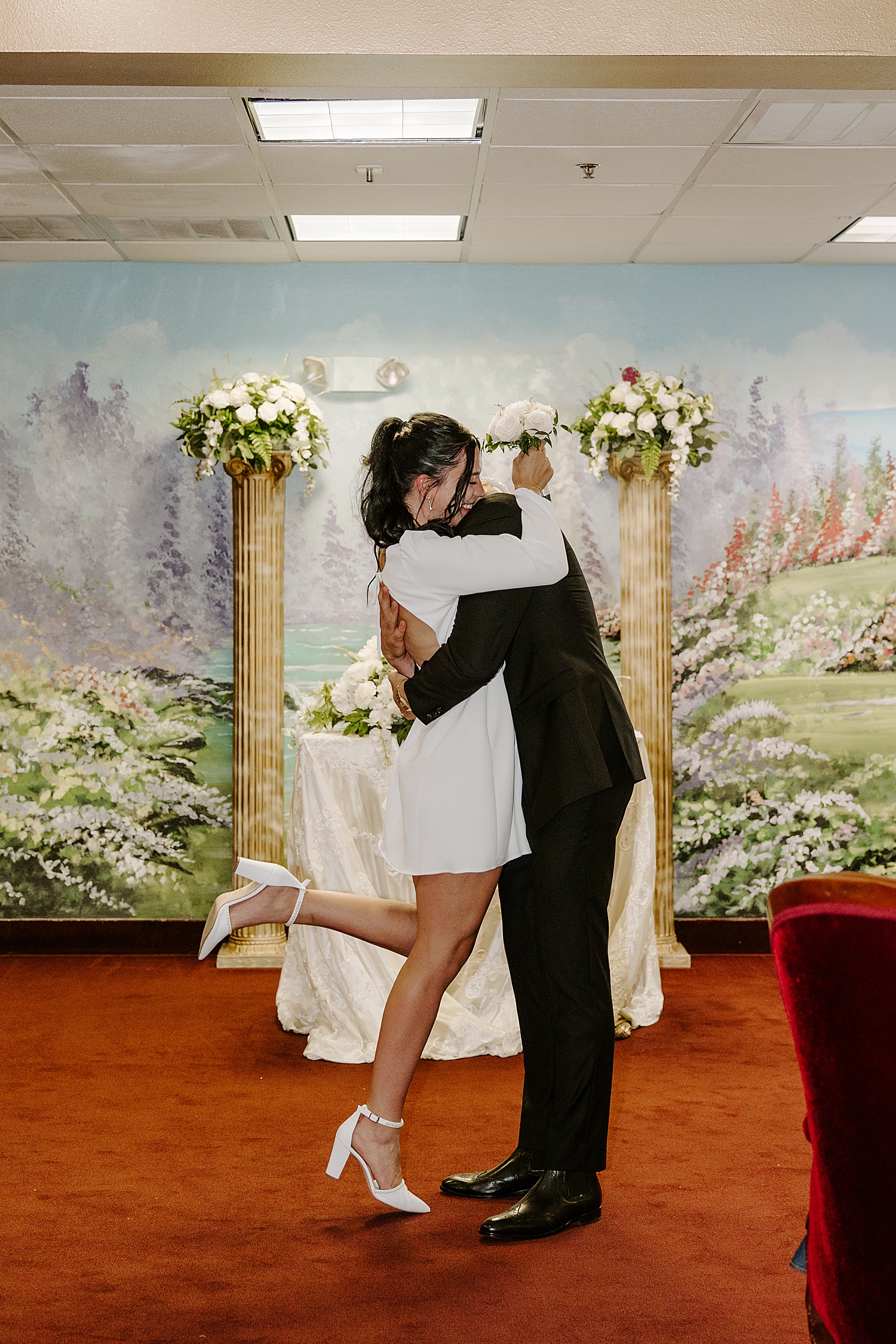 husband and wife hug after saying I Do after learning 5 Most Asked Questions About Eloping in Las Vegas