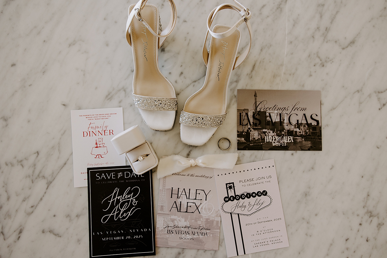 invitation suite and jewelry on marble top for big day at Juno Garden