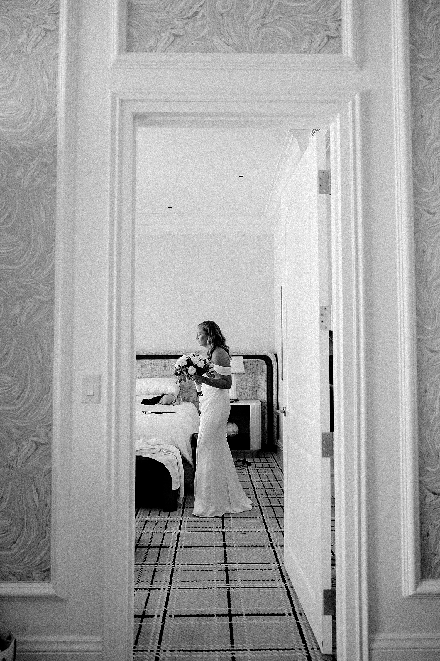 bride stands in doorway before ceremon at Juno Garden