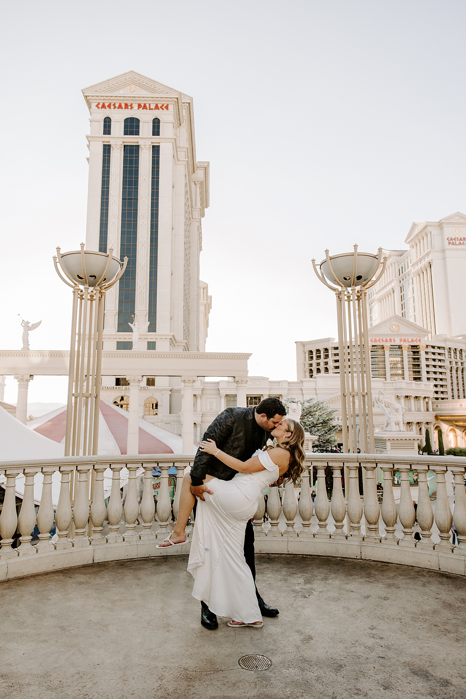 newlyweds share a passionate kiss on the rooftop at Juno Garden