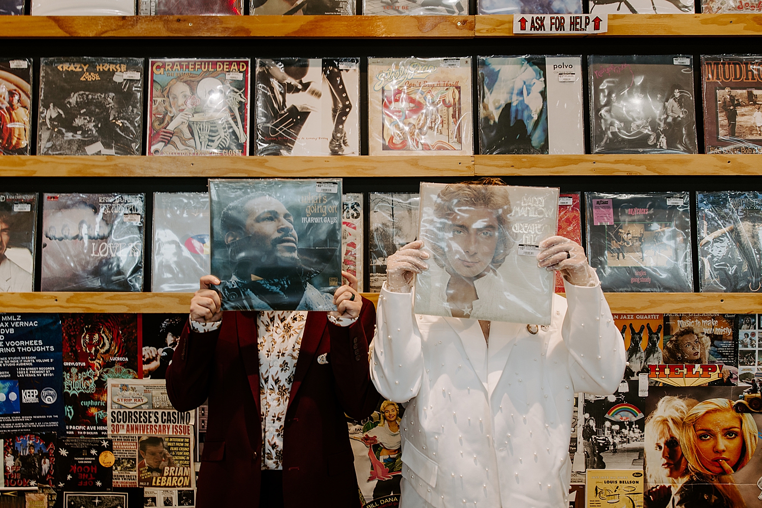 men hide faces behind two vinyls by Katelyn Faye Photo