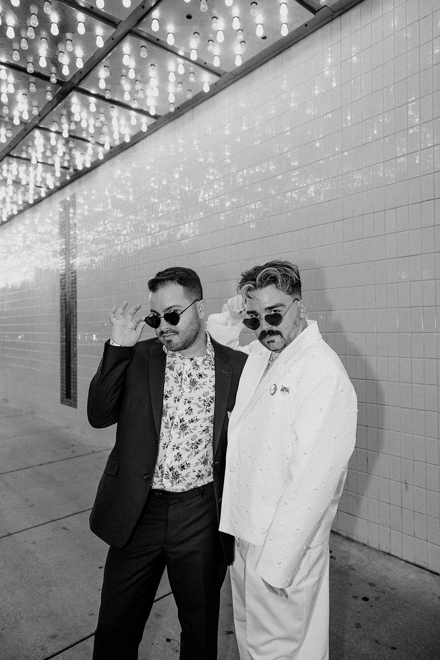 newlyweds tip their sunglasses down on sidewalk by Katelyn Faye Photo