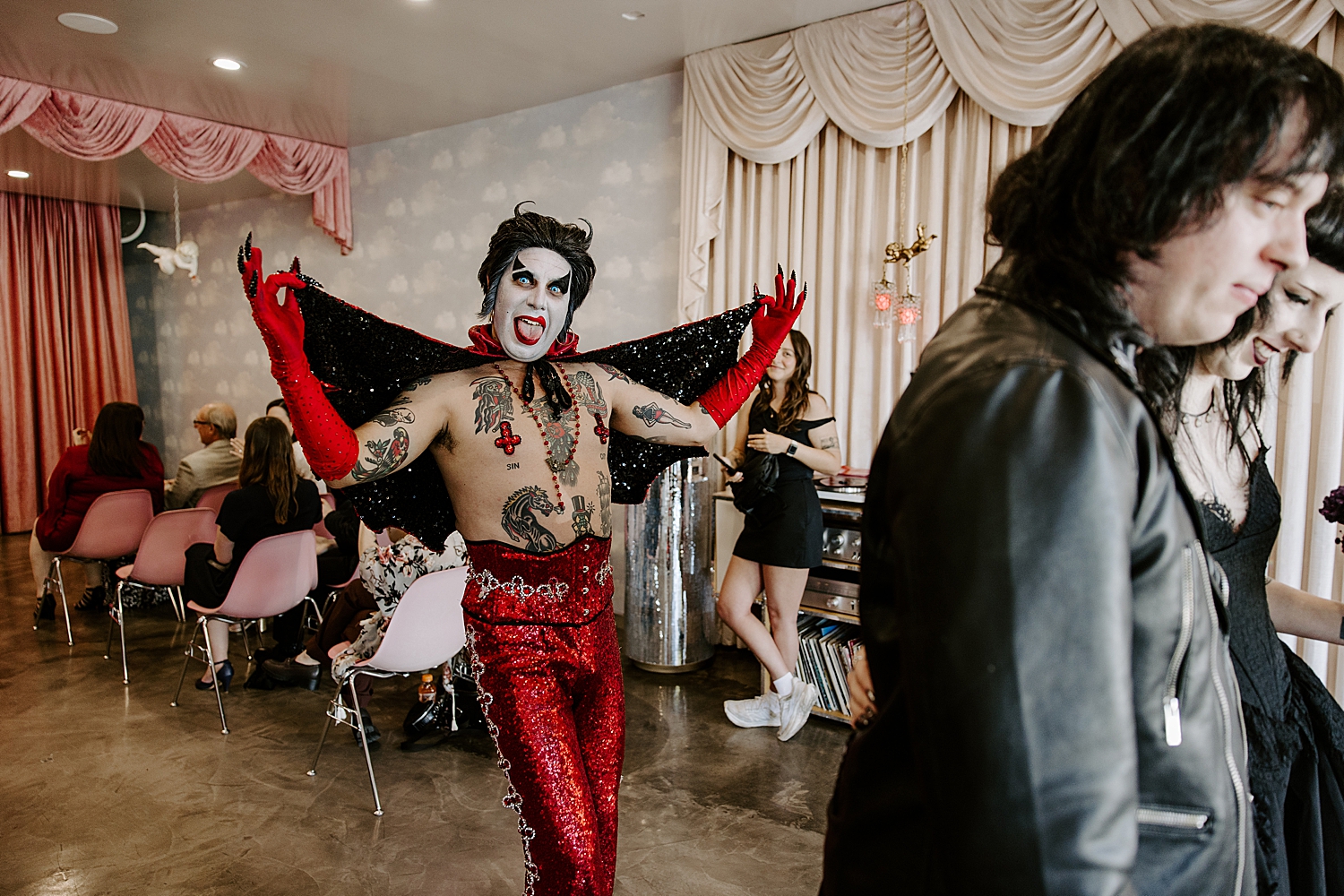 bad elvis in red sparkles shows off his costume by Las Vegas wedding photographer