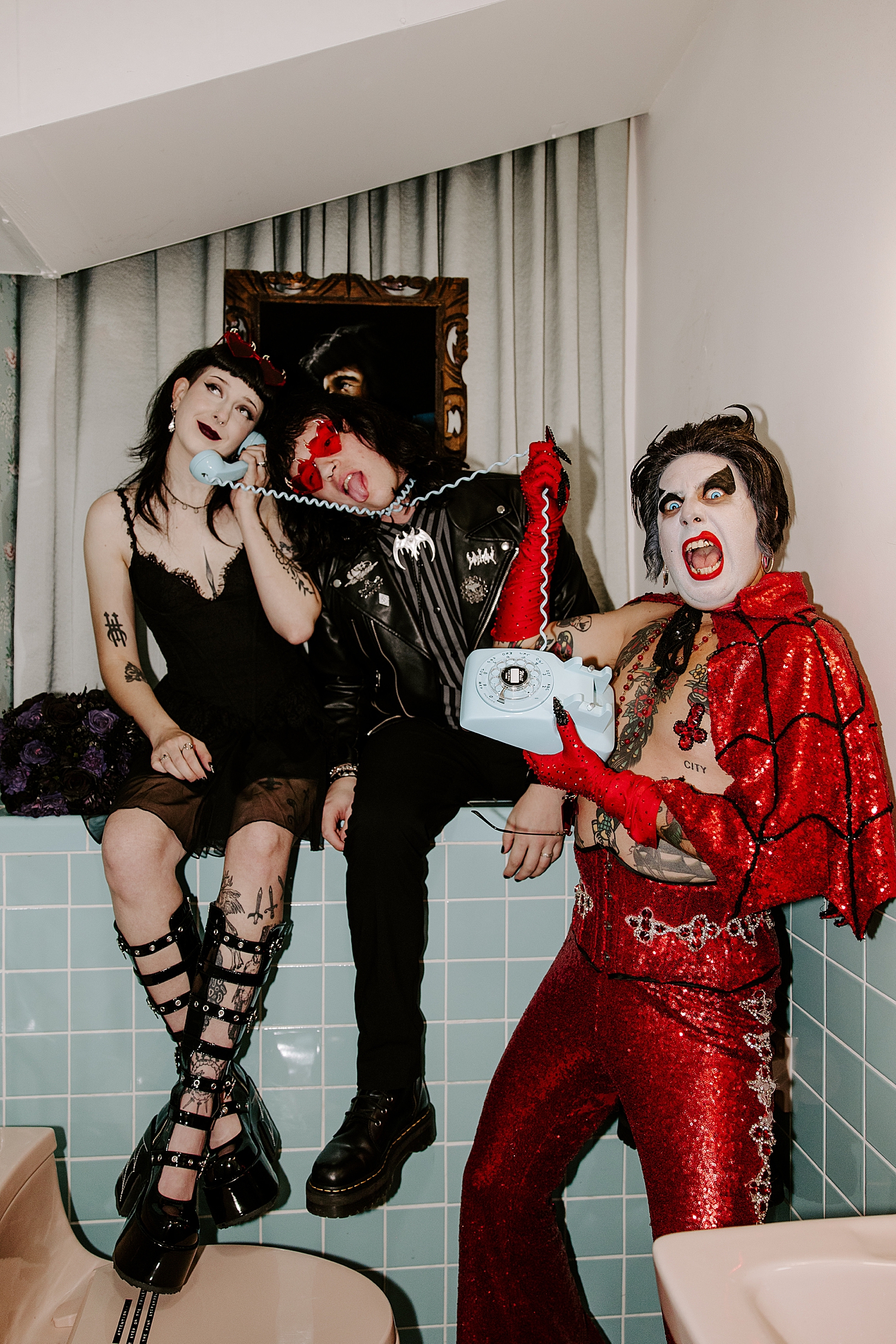 impersonator in red sparks holds up phone in bathroom by Katelyn Faye Photo