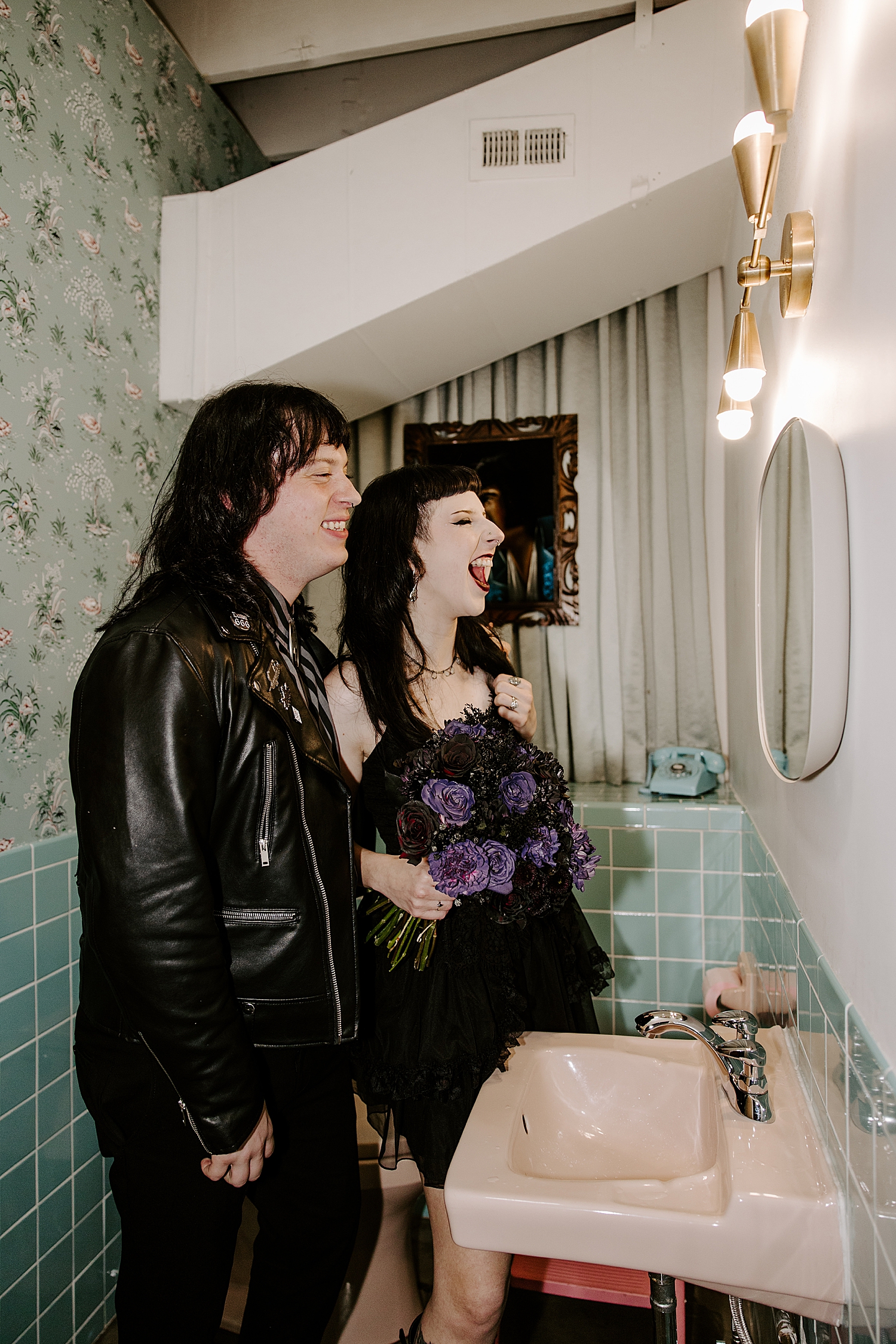 man and woman who just got married make faces in mirror by Las Vegas wedding photographer