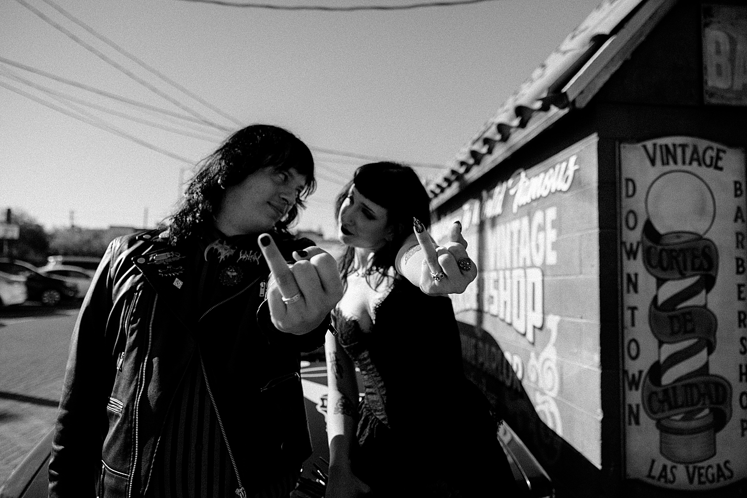 newlyweds show their rings to the camera while wearing black by Katelyn Faye Photo