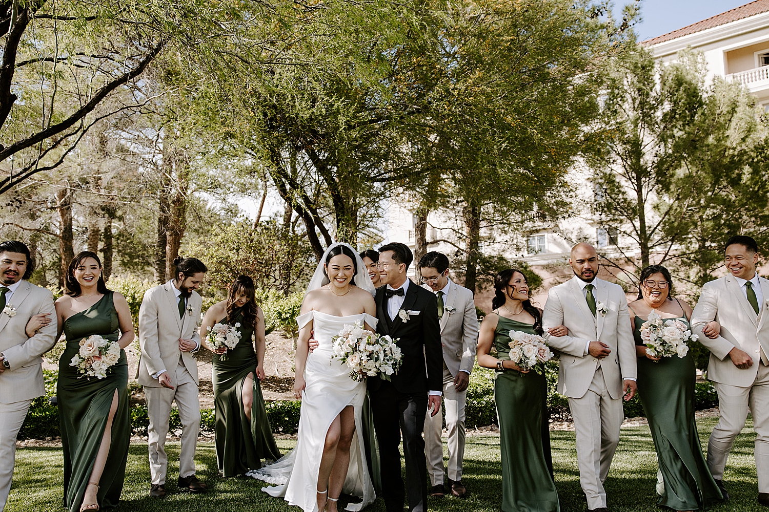 newly married husband and wife walk with bridal party by Katelyn Faye Photo