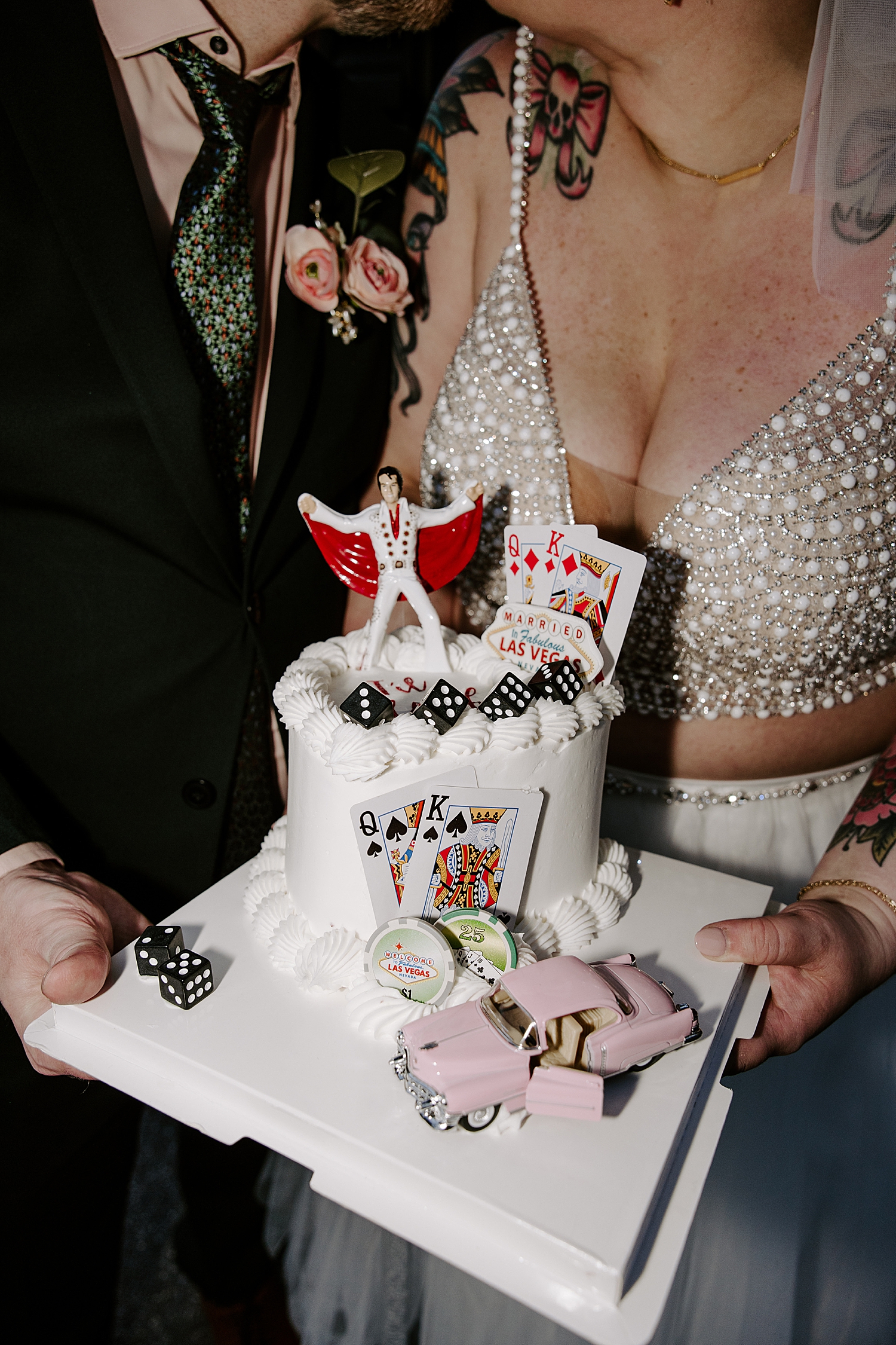 bride and groom show off custom cake with cards and elvis by Katelyn Faye Photography