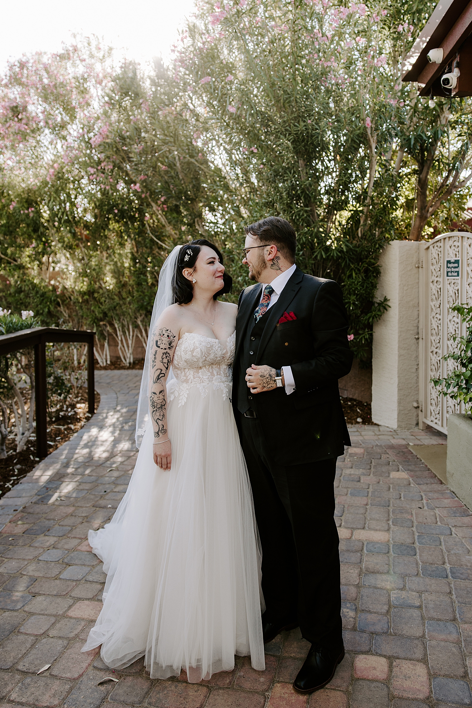 husband and wife stand on patio together at The Grove