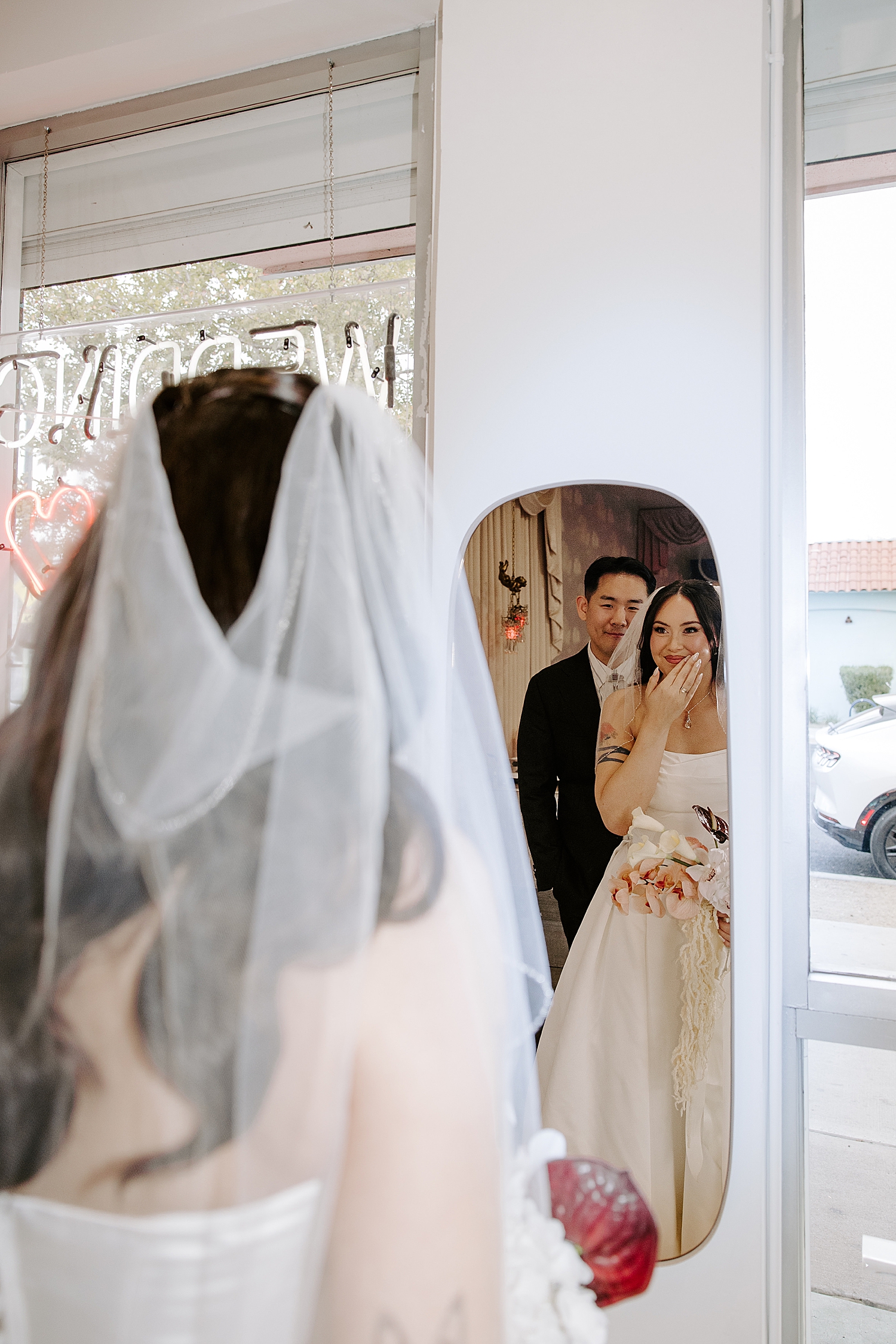 bride giggles in the mirror before ceremony by Katelyn Faye Photo