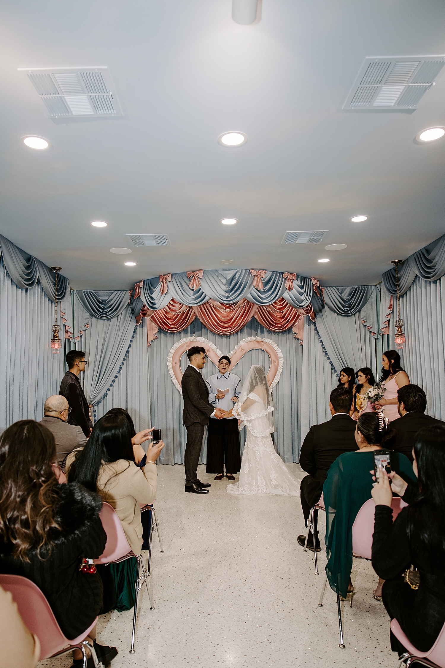 newlyweds say I Do at alter in chapel  at vintage aesthetic wedding