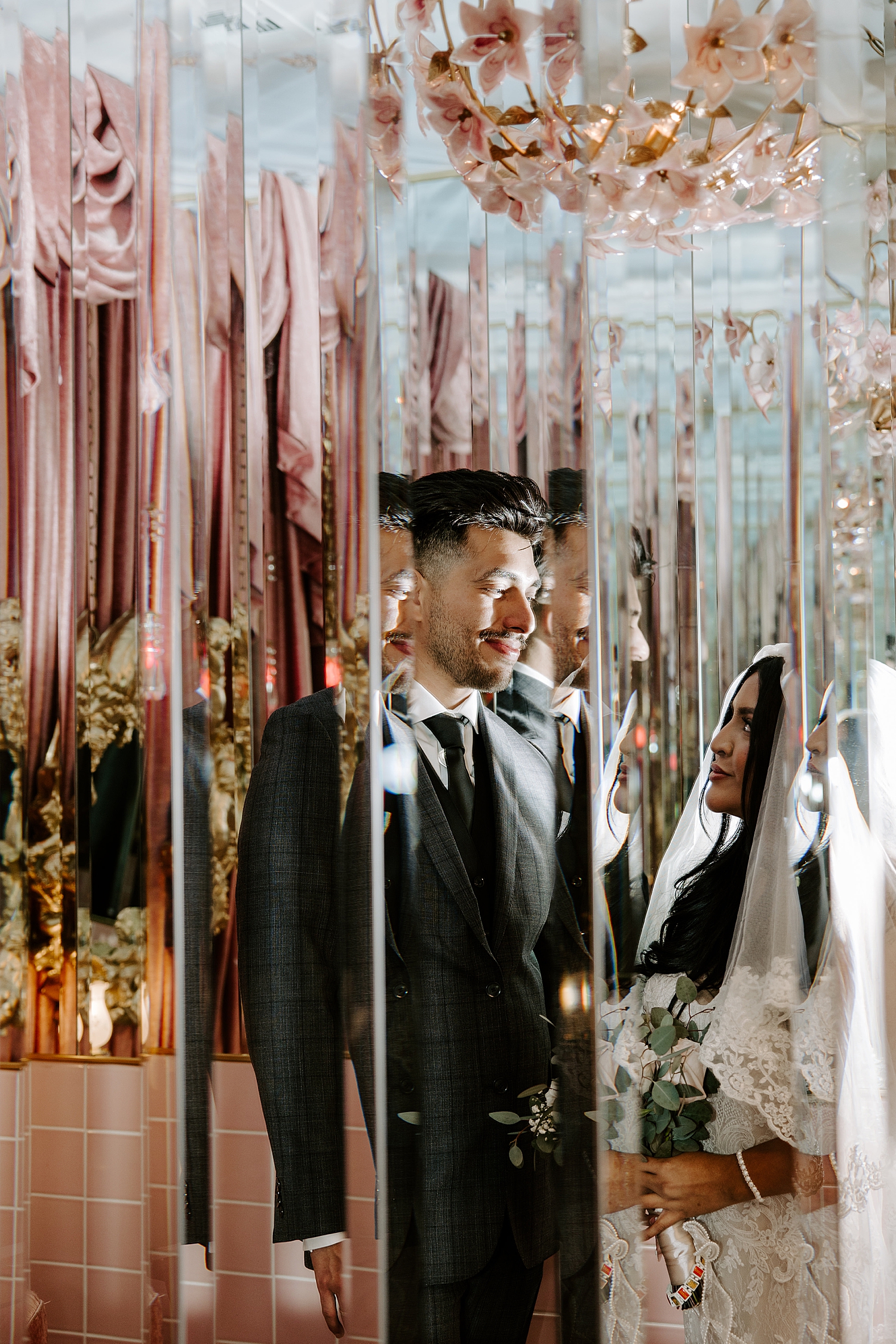 man gazes at his bride through mirror reflections by Las Vegas elopement photographer