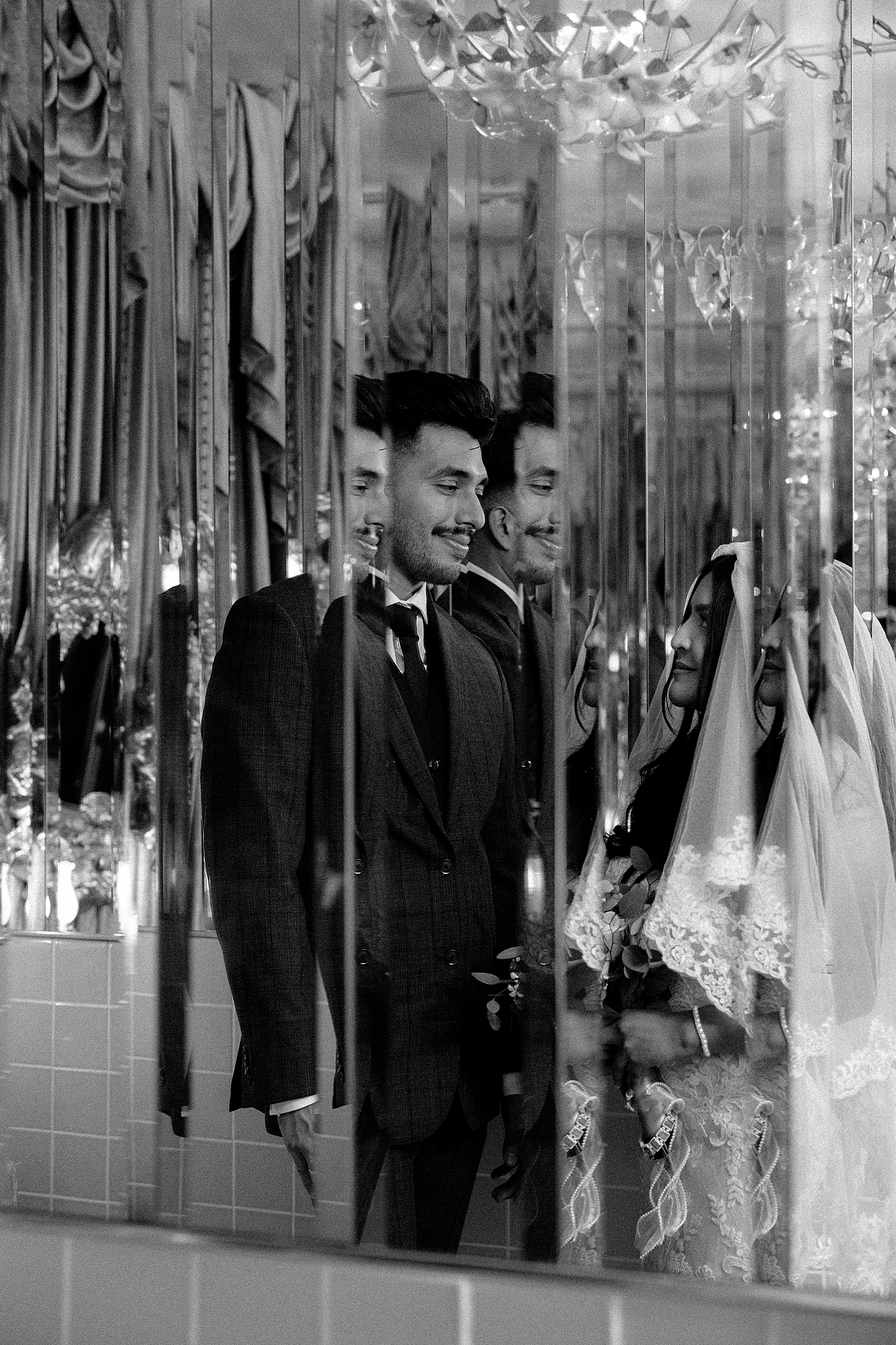 couple gazes at each other through bathroom mirror by Katelyn Faye Photography