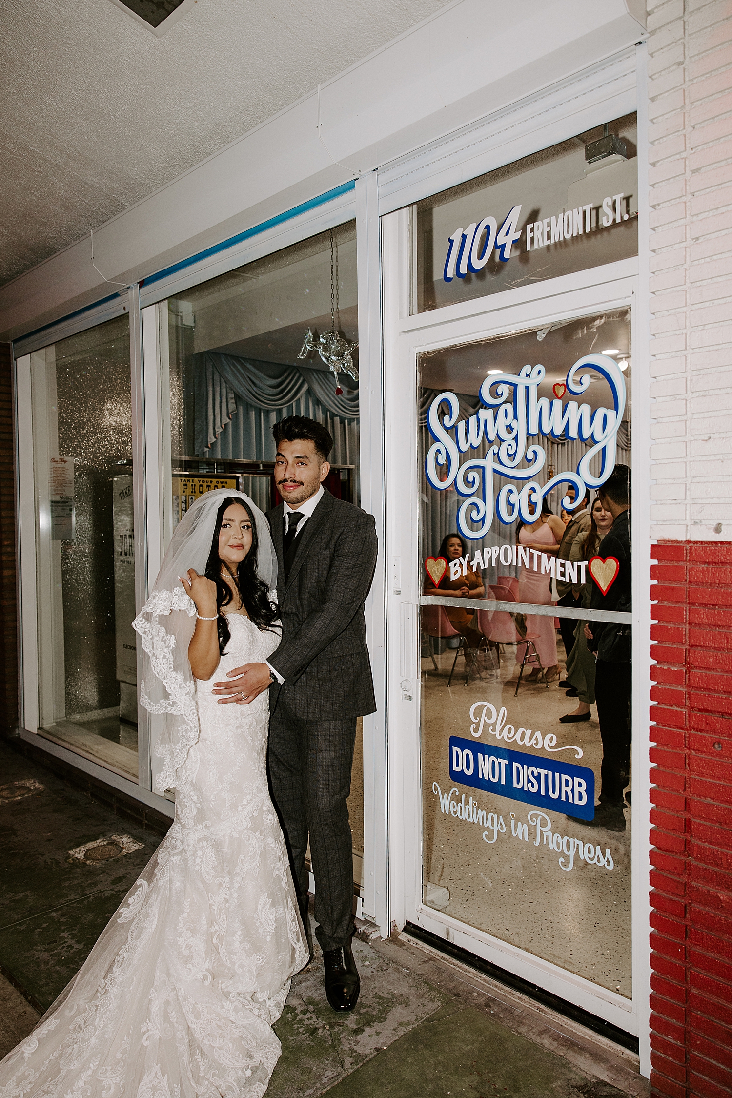 husband and wife stand outside Sure Thing Too by Las Vegas elopement photographer