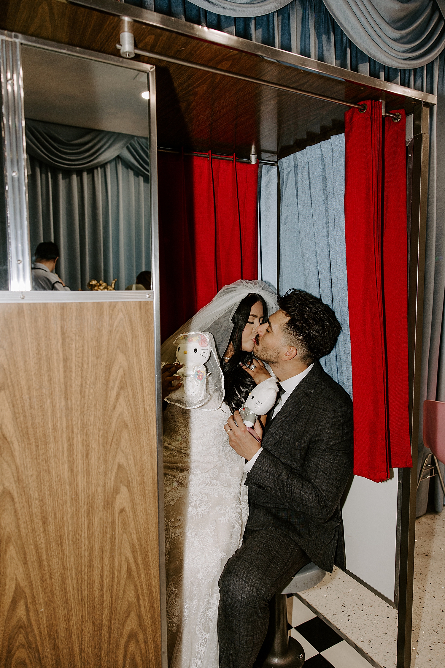 newlyweds share a kiss in photo booth by Las Vegas elopement photographer